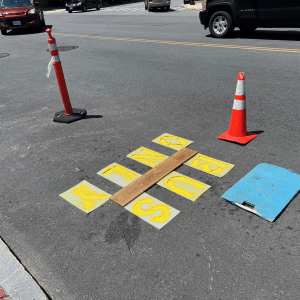 Traffic cones protecting active pavement marking work