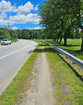 Desire Path Worn by People walking and Biking Along Insufficient Infrastructure along Route 110.